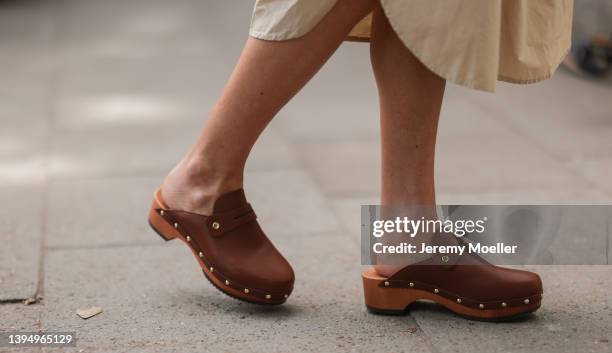 Sue Giers seen wearing a beige midi dress from SoSue and brown clogs on April 29, 2022 in Hamburg, Germany.