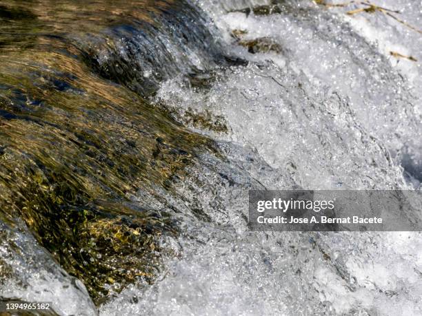 full frame of moving water surface of a river in nature. - riverbed stock pictures, royalty-free photos & images