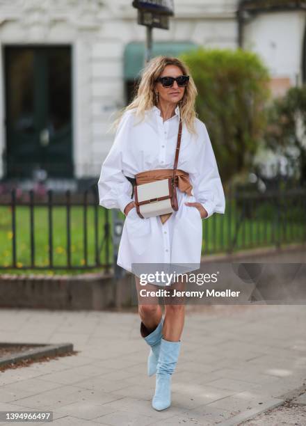 Sue Giers seen wearing brown sunglasses from Jacquemus, a white SoSue mini shit dress, a brown Isabel Marant bag, a brown leather belt from Closed...