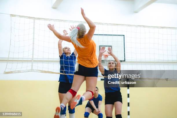 female volleyball player spiking the ball - spiking stock pictures, royalty-free photos & images