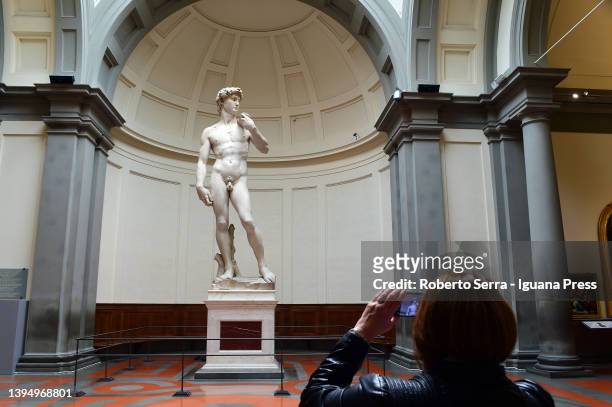 Visitor admires the David statue by italian rinascimental artist Michelangelo Buonarroti during the presentation of the celebrations for the 140th...