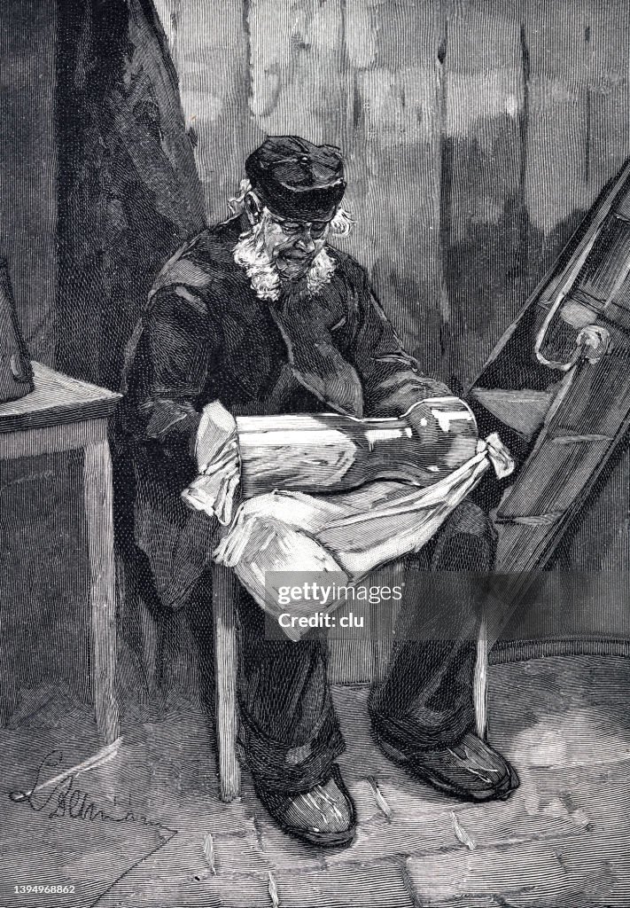 On the lighthouse, man sitting on chair cleaning the cylinder