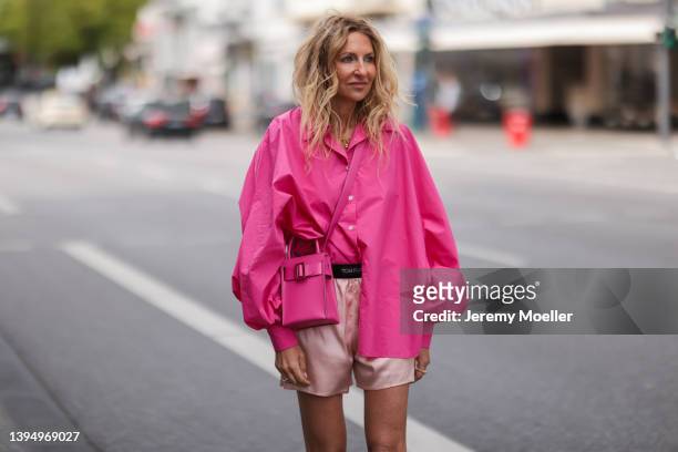 Sue Giers seen wearing a pink SoSue shirt blouse, a pale pink silk Tom Ford shorts and a pink bag from Boyy on April 29, 2022 in Hamburg, Germany.