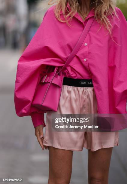 Sue Giers seen wearing a pink SoSue shirt blouse, a pale pink silk Tom Ford shorts and a pink bag from Boyy on April 29, 2022 in Hamburg, Germany.