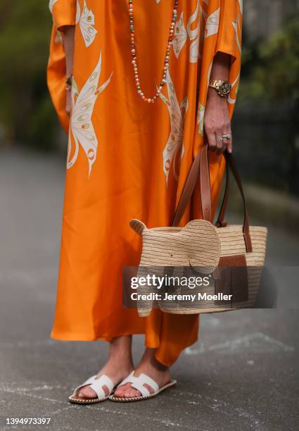 Yasmin von Schlieffen-Nannen seen wearing an orange kimono dress from Pucci, a basket bag from Loewe and white leather sandals from Hermes on April...