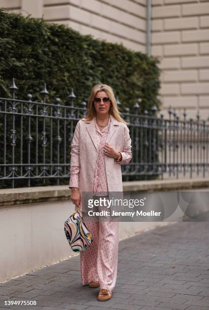 Yasmin von Schlieffen-Nannen seen wearing a Cartier sunglasses, a pale pink silk pyjama from Lanvin, a pale pink coat from Paul & Joe, a silk bag...