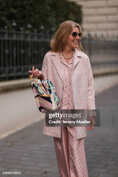 Yasmin von Schlieffen-Nannen seen wearing a Cartier sunglasses, a pale pink silk pyjama from Lanvin, a pale pink coat from Paul & Joe, a silk bag...