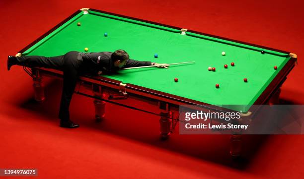 Ronnie O'Sullivan of England plays a shot during the Betfred World Snooker Championship Final match between Judd Trump of England and Ronnie...