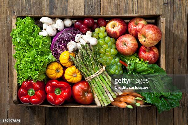crate full of fruits and vegetables over rustic table - vegetable stock pictures, royalty-free photos & images