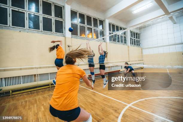 female volleyball player spiking the ball - spiking stock pictures, royalty-free photos & images