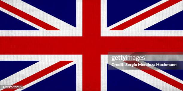 flag of the united kingdom, the union jack, with a grunge linen texture, british flag - england flag foto e immagini stock