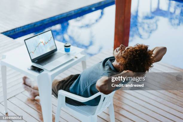 working by the pool - share trading stock pictures, royalty-free photos & images