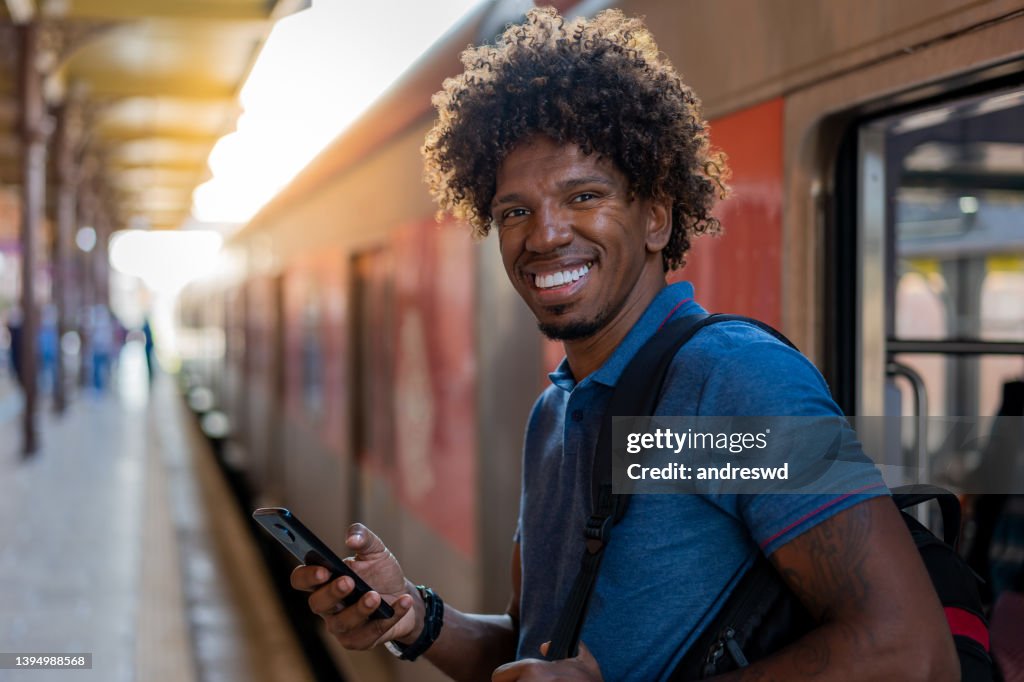 Man on subway train using smartphone