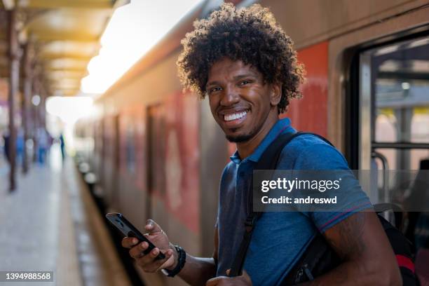 man on subway train using smartphone - brazilian people stock pictures, royalty-free photos & images