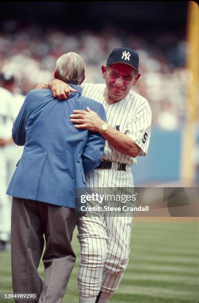 Yankee greats Phil Rizzuto and Yogi Berra, playing around during introductions at the Annual Old Timers Day at Yankee Stadium on June 26, 1999 in New...