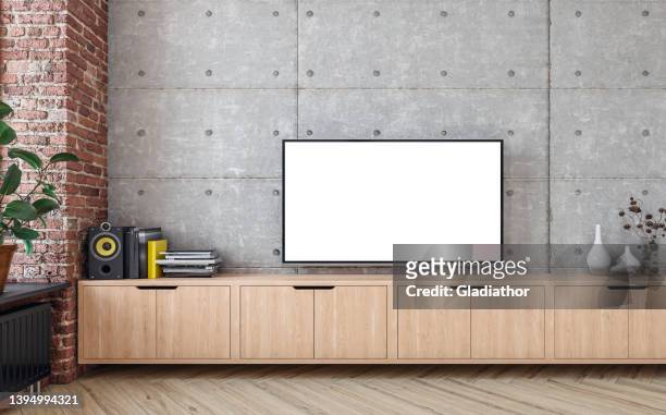 modern living room with a tv on a cabinet - tv on wall stockfoto's en -beelden