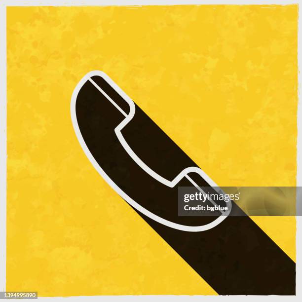 phone. icon with long shadow on textured yellow background - long shadow stock illustrations