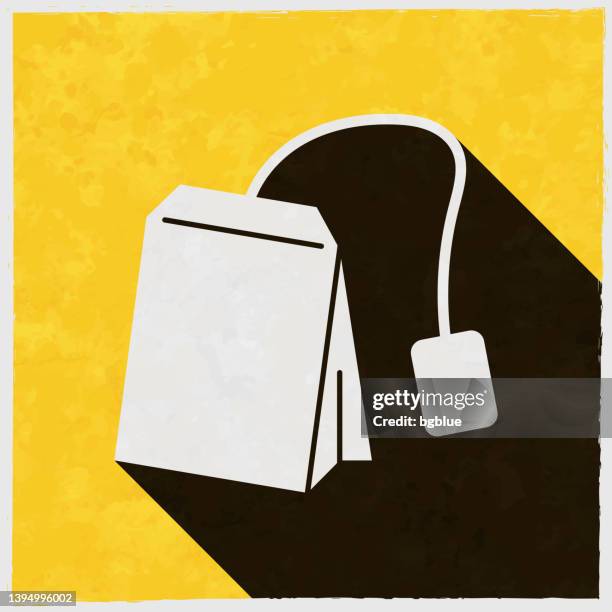 tea bag. icon with long shadow on textured yellow background - herbal tea bag stock illustrations