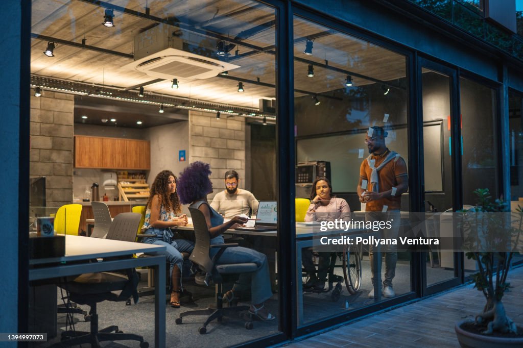 People working in creative office at night