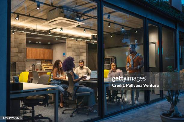 people working in creative office at night - creative space stock pictures, royalty-free photos & images