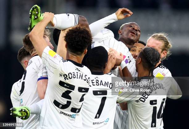 Jean Michael Seri of Fulham celebrates with team mates after scoring their team's sixth goal during the Sky Bet Championship match between Fulham and...