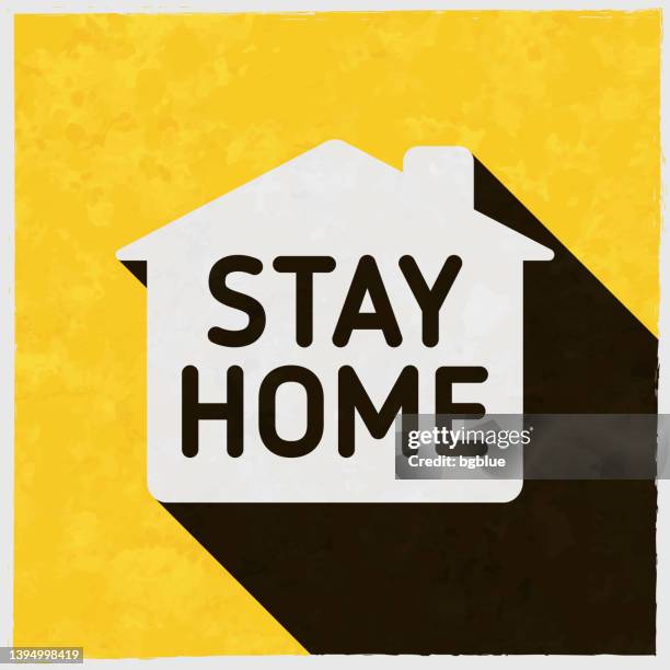 stay home. icon with long shadow on textured yellow background - stay at home order stock illustrations