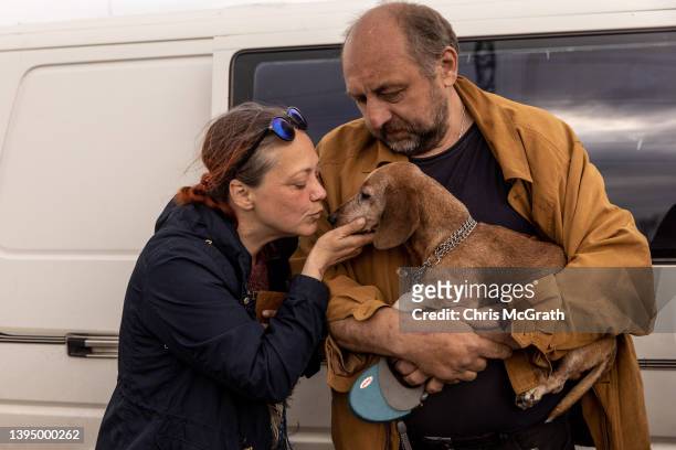 Woman from Mariupol kisses her dog after arriving at an evacuation point for people fleeing Mariupol, Melitopol and the surrounding towns under...