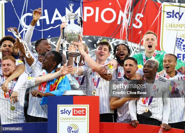 Tom Cairney of Fulham lifts the trophy as Players of Fulham celebrate winning the Sky Bet Championship and promotion to the Premier League after the...