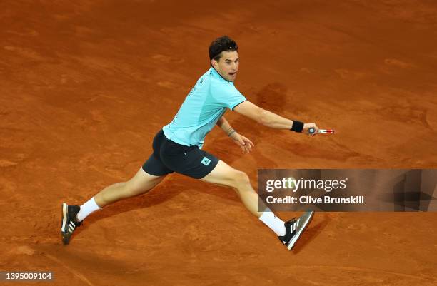 Dominic Thiem of Austria plays a backhand shot against Andy Murray of Great Britain during their First Round match on day five of the Mutua Madrid...