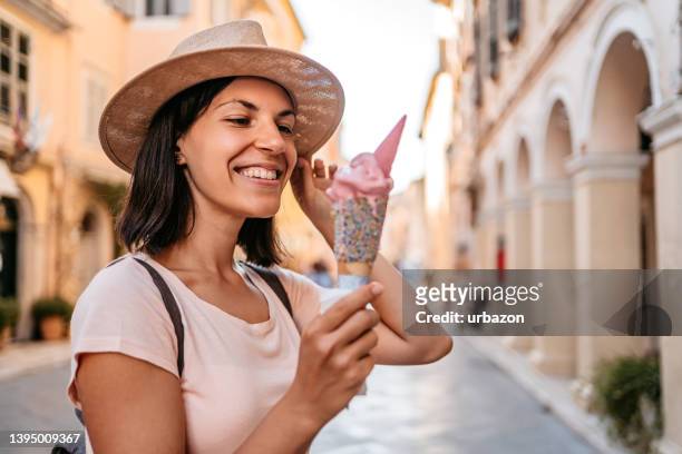 joven turista comiendo helado - greece city fotografías e imágenes de stock