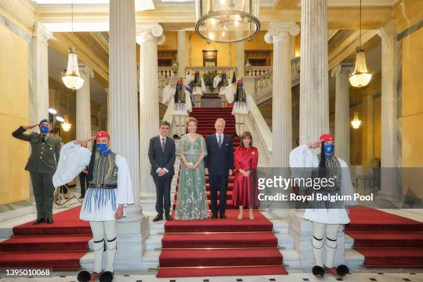 Mr Pavlos Kotsonis, King Philippe of Belgium, Queen Mathilde and President of Greece Katerina Sakellaropoulou pose surrounded by guards wearing a...