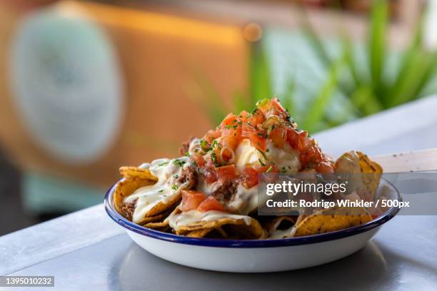 close-up of food in bowl on table,new plymouth,new zealand - nachos stock pictures, royalty-free photos & images