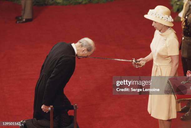 Queen Elizabeth II bestows a knighthood in Wellington during her tour of New Zealand, 1977.