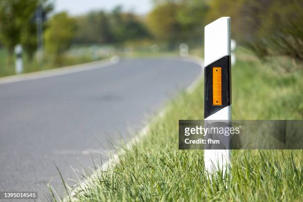 road marking post next to the road - bollards foto e immagini stock