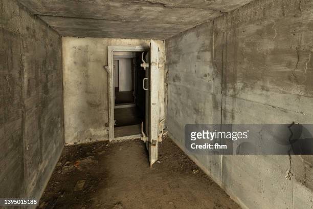 tunnel to the bunker with open gate - sótano fotografías e imágenes de stock