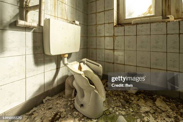 destroyed toilet in an abandoned building - messy apartment stock pictures, royalty-free photos & images