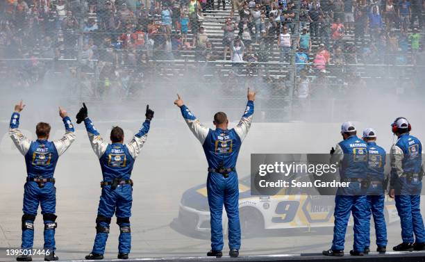 Chase Elliott, driver of the NAPA Auto Parts Chevrolet, celebrates with a burnout as his crew cheer from the wall after winning the NASCAR Cup Series...