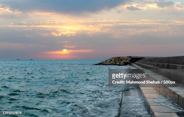 scenic view of sea against sky during sunset - groyne stock pictures, royalty-free photos & images
