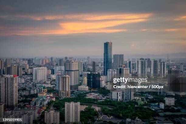 aerial view of modern buildings in city against sky during sunset,hanoi,vietnam - hanoi cityscape stock pictures, royalty-free photos & images