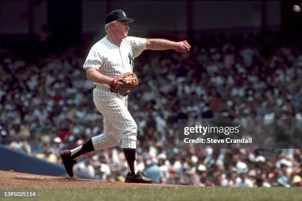 Yankee great Whitey Ford delivers a pitch during the Annual Old Timers Day game at Yankee Stadium on July 11,1988 in New York, United States.