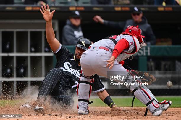Jose Abreu of the Chicago White Sox beats the tag at home plate against Kurt Suzuki of the Los Angeles Angels to score in the sixth inning at...