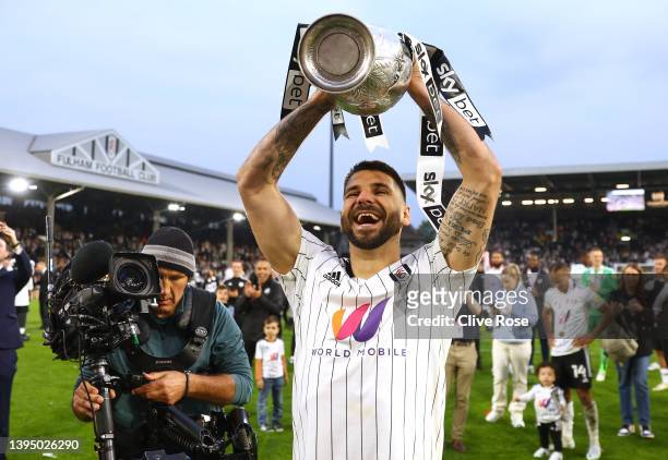 Aleksandar Mitrovic of Fulham lifts the Sky Bet Championship Trophy as Players of Fulham celebrate winning the Sky Bet Championship and promotion to...