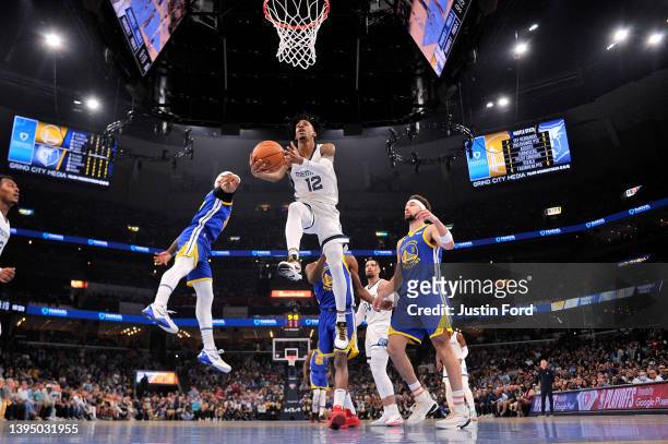 Ja Morant of the Memphis Grizzlies goes to the basket against Klay Thompson of the Golden State Warriors during Game One of the Western Conference...