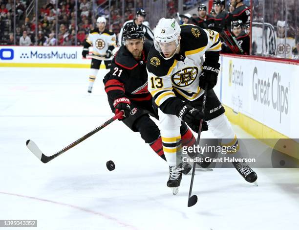 Nino Niederreiter of the Carolina Hurricanes battles Charlie Coyle of the Boston Bruins for the puck during the first period of Game One of the First...