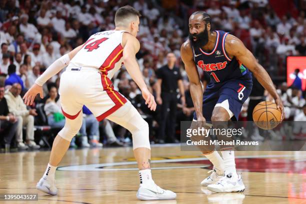 James Harden of the Philadelphia 76ers is defended by Tyler Herro of the Miami Heat during the first quarter in Game One of the Eastern Conference...