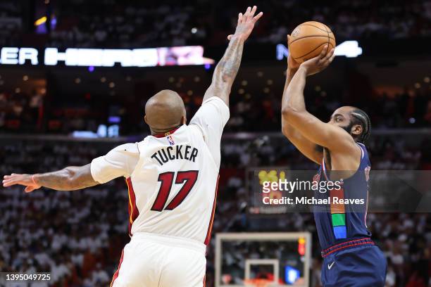 James Harden of the Philadelphia 76ers shoots a three pointer over P.J. Tucker of the Miami Heat during the first half in Game One of the Eastern...