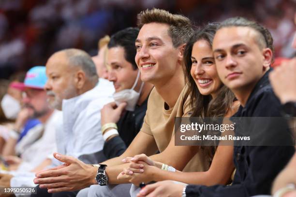 George Russell of Great Britain and Mercedes F1 driver looks on courtside during the first half in Game One of the Eastern Conference Semifinals...