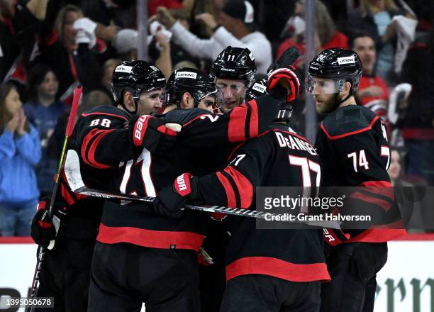 Teammates celebrate with Nino Niederreiter of the Carolina Hurricanes after his goal against the Boston Bruins during the second period of Game One...