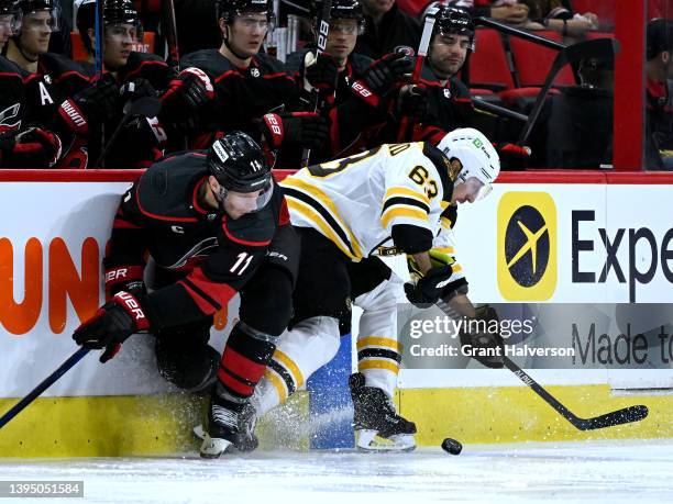 Jordan Staal of the Carolina Hurricanes and Brad Marchand of the Boston Bruins compete for the puck during the second period of Game One of the First...