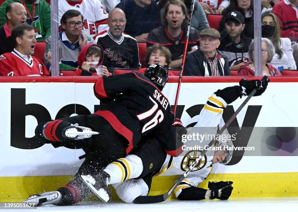 Brady Skjei of the Carolina Hurricanes checks Tomas Nosek of the Boston Bruins during the second period of Game One of the First Round of the 2022...